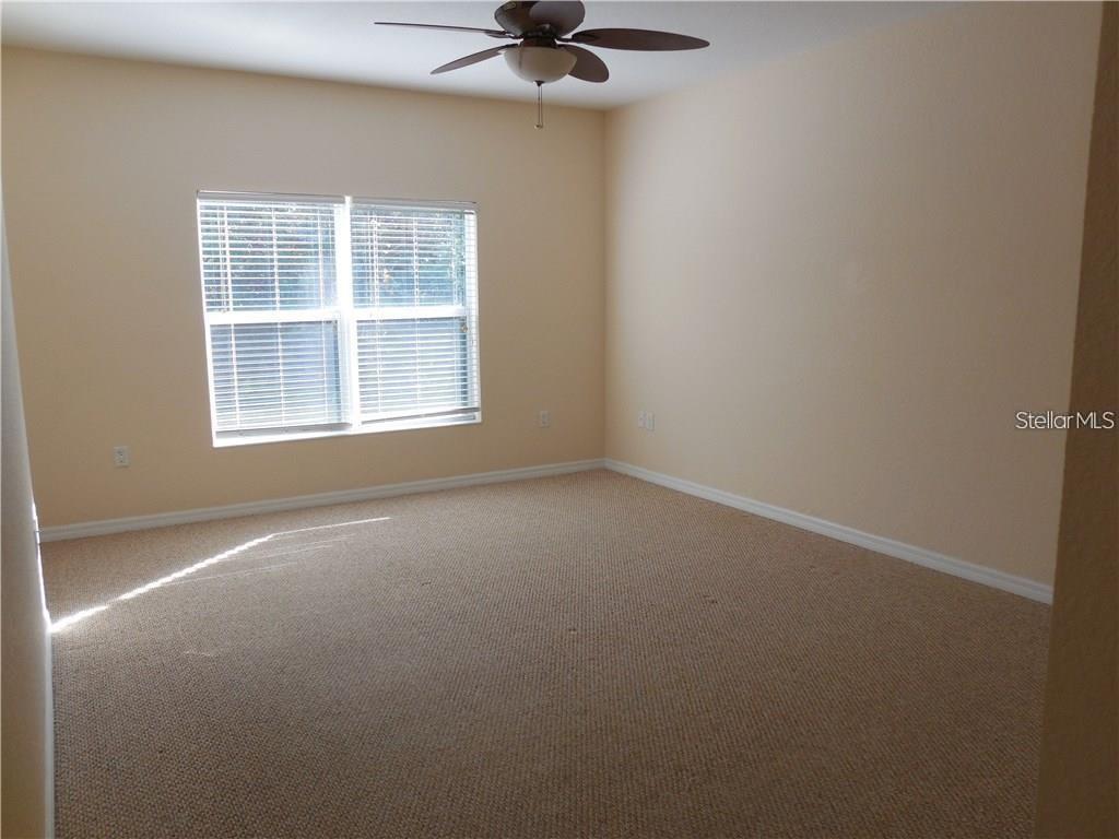 6405 Bay Cedar Lane, Unit 26 Bradenton, FL 34203 - Photo 10 of 19 an empty room with a window