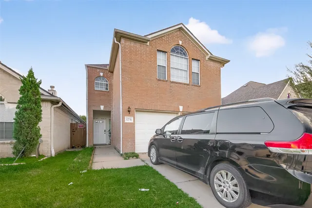 a view of a car parked in front of a house