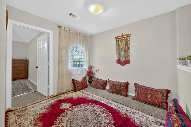 a spacious bedroom with a bed and a walk in closet