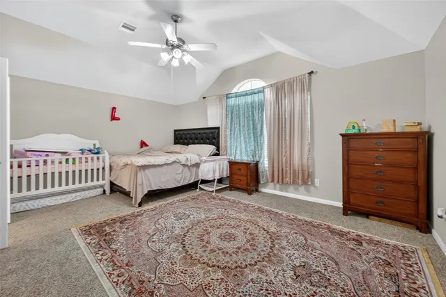 a bedroom with furniture and a chandelier