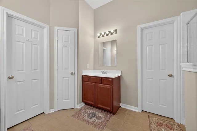 a bathroom with a tub shower and hallway
