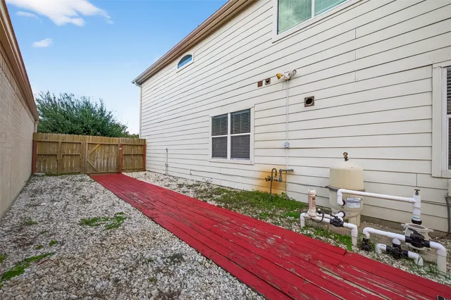 a view of a swimming pool with a patio and a yard