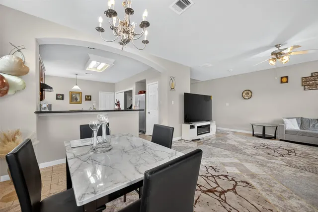 a kitchen with stainless steel appliances granite countertop a stove a sink dishwasher and a refrigerator