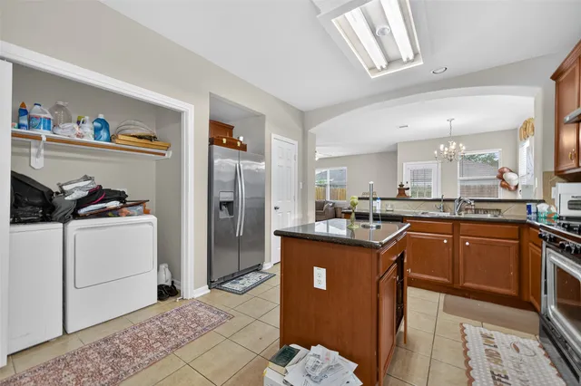 a kitchen with stainless steel appliances granite countertop a refrigerator and a sink