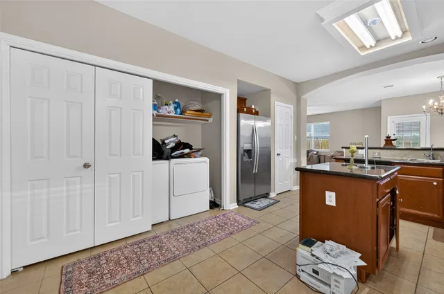 a kitchen with stainless steel appliances granite countertop a sink refrigerator and cabinets