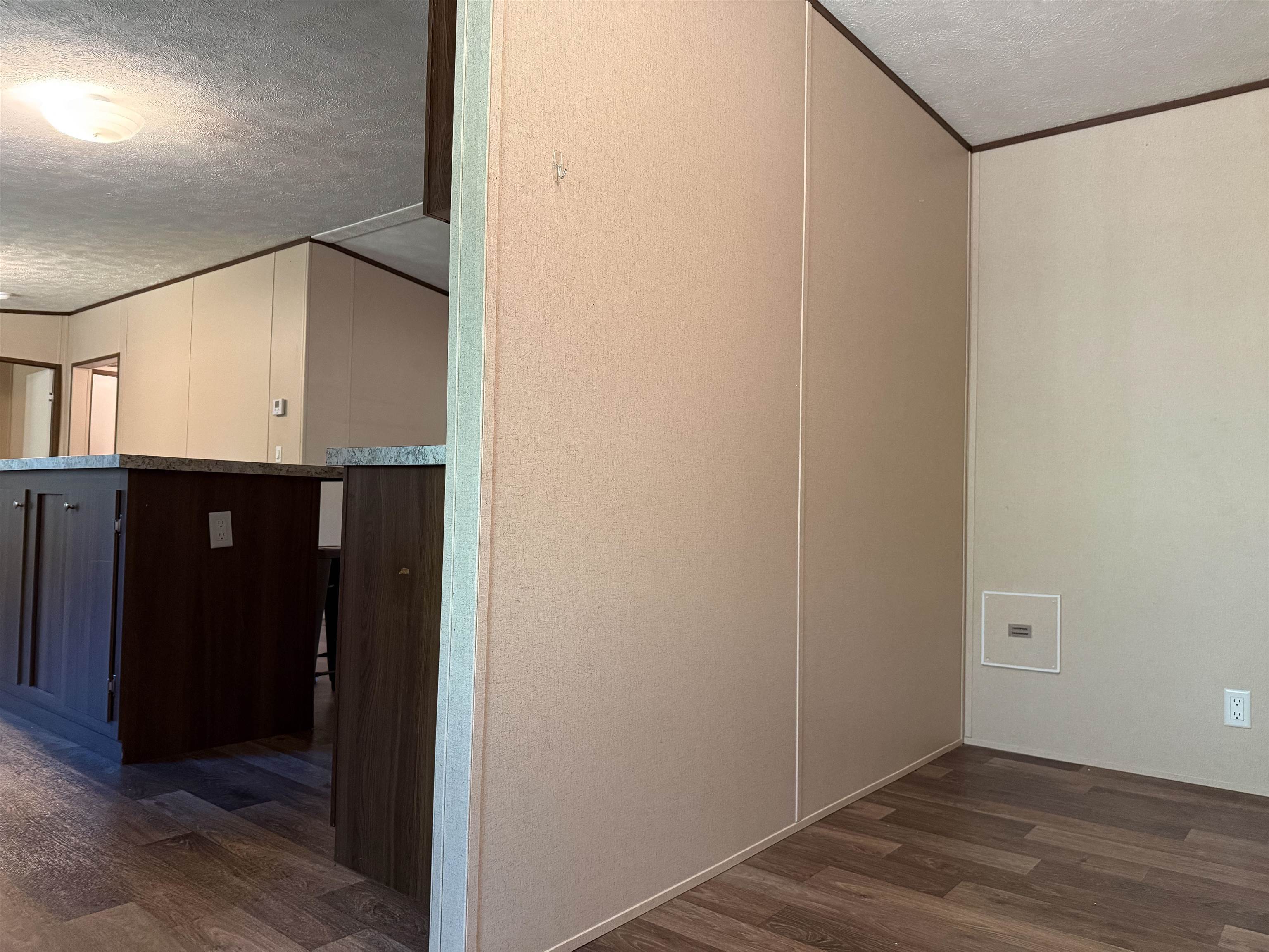 279 Travis Road Brewton, AL 36426 - Photo 14 of 17 Hall with a textured ceiling, dark wood finished floors, and ornamental molding