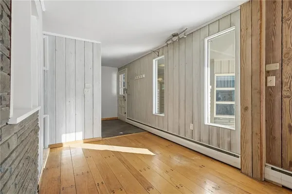 a view of a room with wooden floor and a window