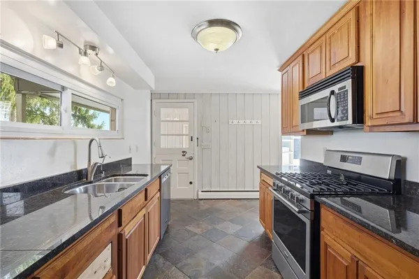 a kitchen that has a sink and a stove
