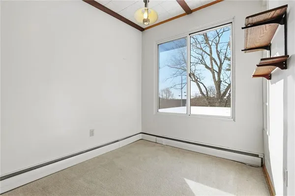 a view of a livingroom with wooden floor and a window