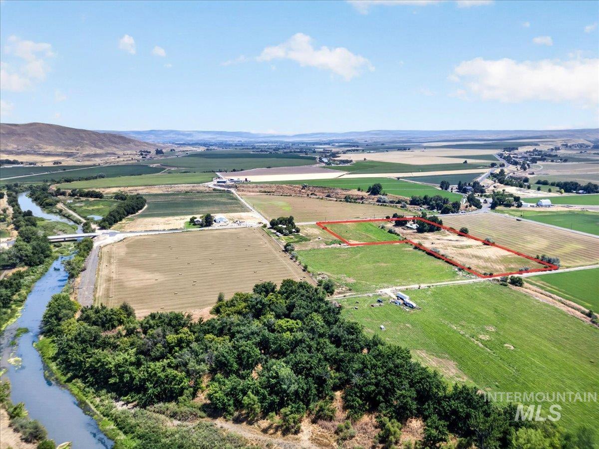 587 Cove Road Weiser, ID 83672 - Photo 3 of 30 Expansive rural acreage featuring multiple fields, a river, and distant hills