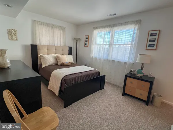 a bedroom with bed couch and window