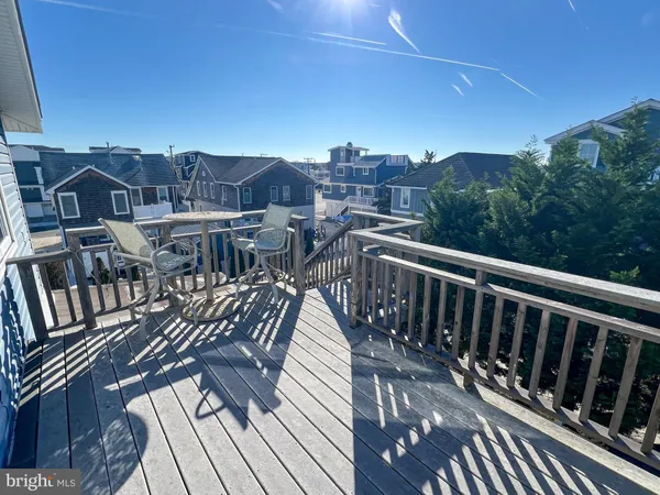 a view of a balcony with wooden floor and city view