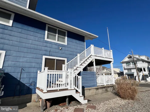 a view of a house with a small deck