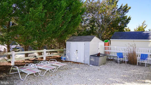 a view of backyard with outdoor seating and trees