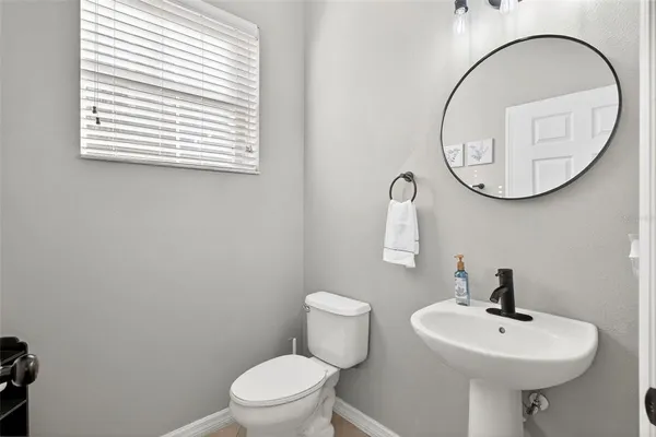 a bathroom with a sink a mirror and a toilet