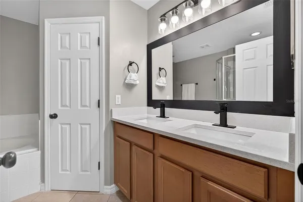 a bathroom with a double vanity sink and a mirror