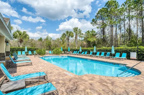a view of a swimming pool with lounge chairs