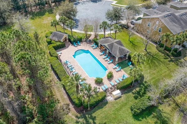 an aerial view of a house with a swimming pool and outdoor seating