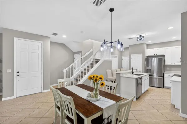 a view of a dining room with furniture and chandelier