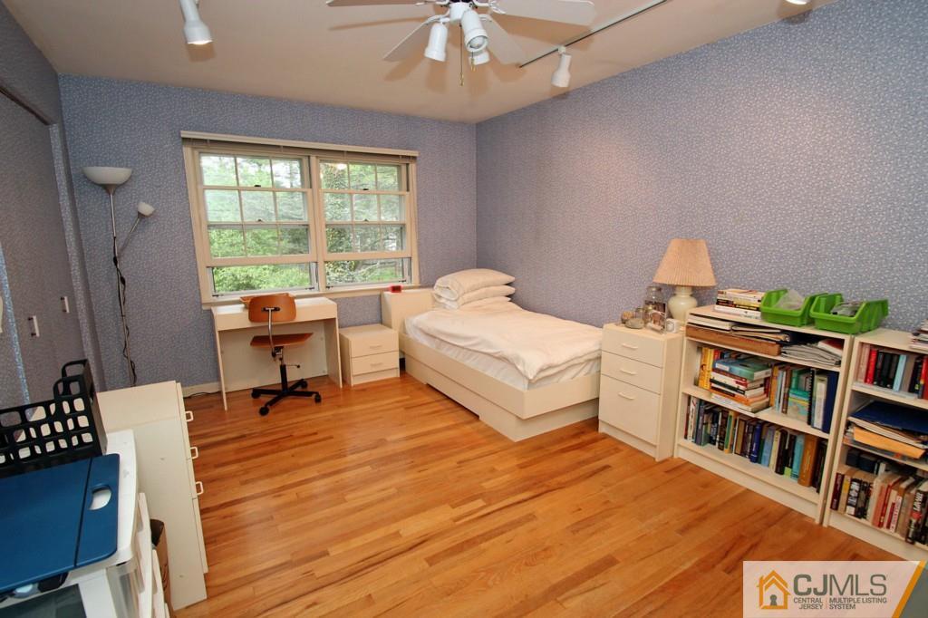 32 Clive Hills Road Edison, NJ 08820 - Photo 22 of 25 a bedroom with furniture and a book shelf