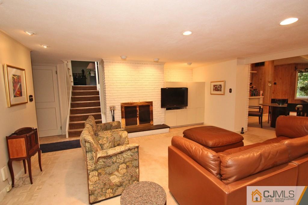 32 Clive Hills Road Edison, NJ 08820 - Photo 8 of 25 a living room with furniture and a flat screen tv