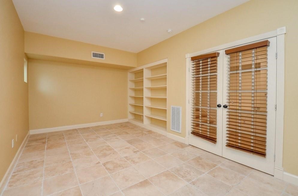 5416 Rose Street Houston, TX 77007 - Photo 11 of 19 Built-in open shelving, with a room featuring French doors and chic shutters.