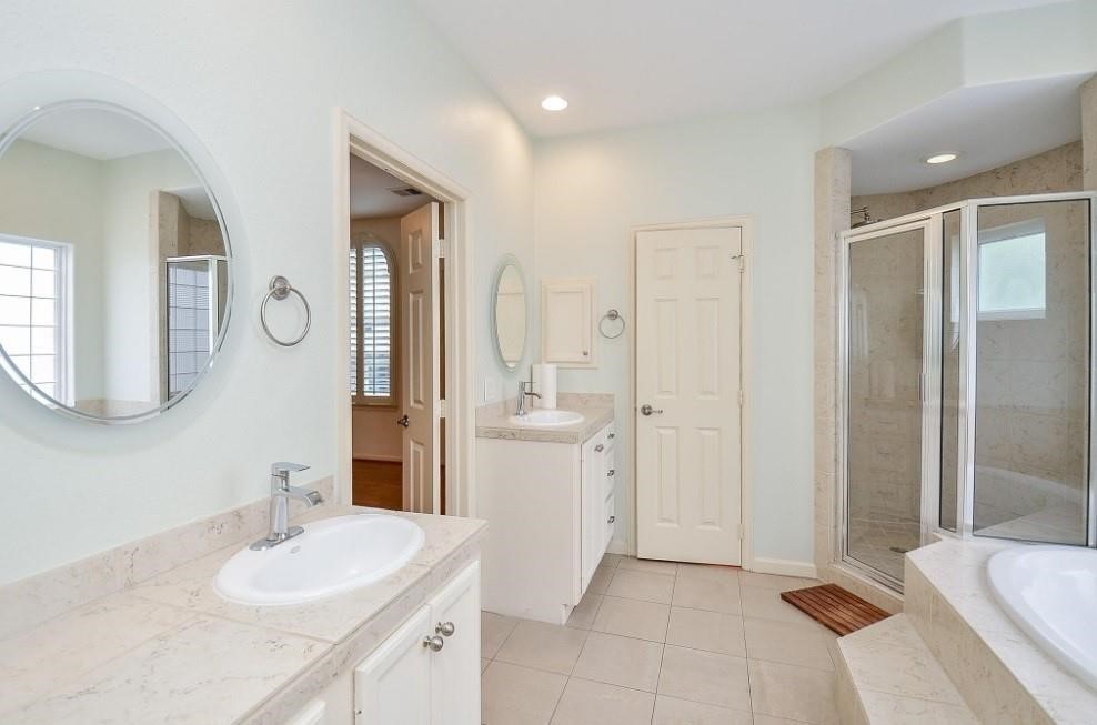 5416 Rose Street Houston, TX 77007 - Photo 15 of 19 Primary bathroom features dual sinks, plus a separate shower and tub for ultimate convenience and relaxation.