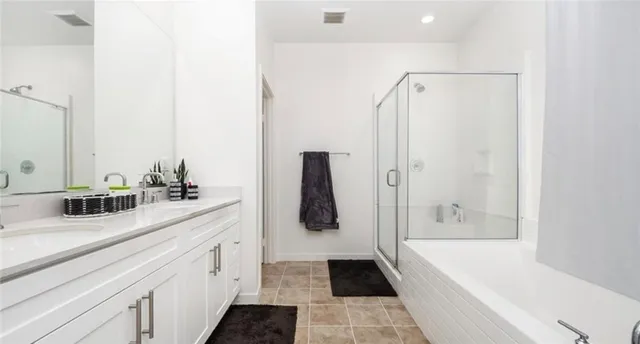a bathroom with a tub sink and mirror