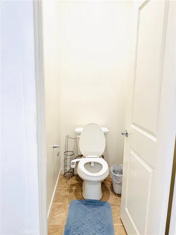 a white toilet sitting next to a sink