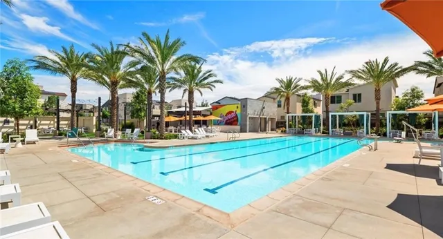 a view of multiple houses with swimming pool and sitting area