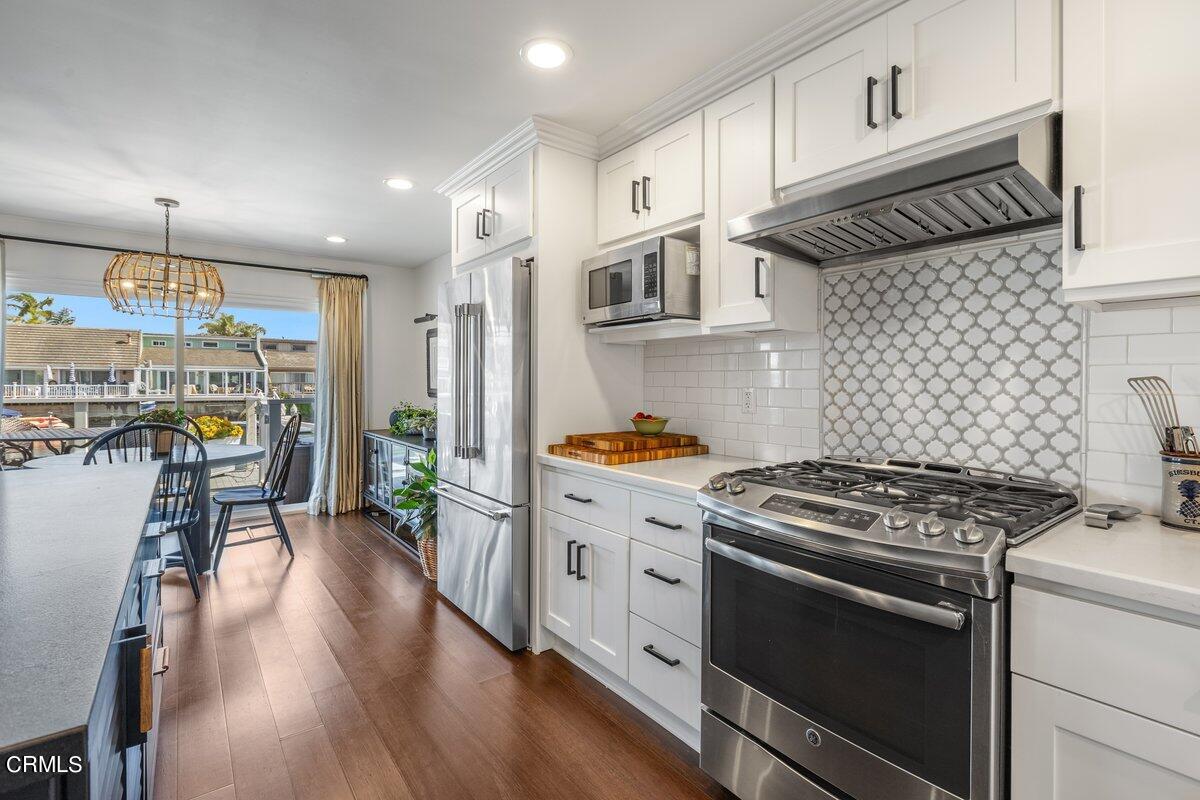4612 Falkirk Bay Oxnard, CA 93035 - Photo 13 of 39 a kitchen with stainless steel appliances a stove a sink and a refrigerator