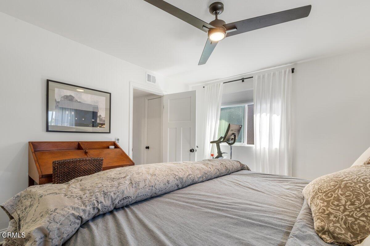 4612 Falkirk Bay Oxnard, CA 93035 - Photo 26 of 39 a bedroom with a bed and a chandelier