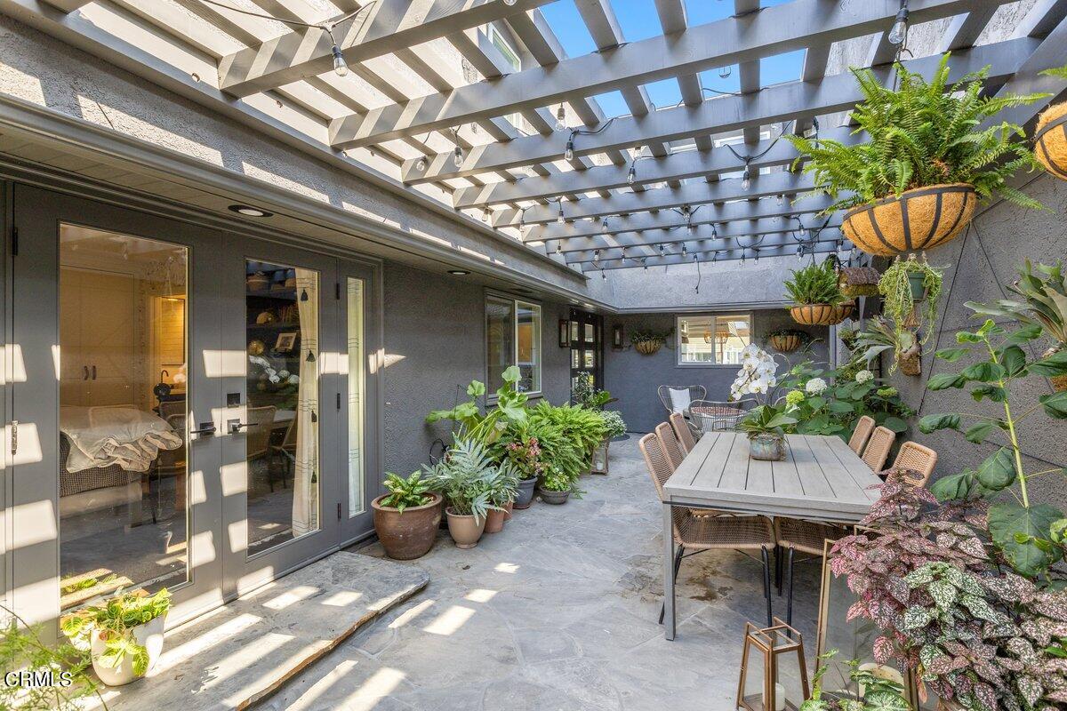 4612 Falkirk Bay Oxnard, CA 93035 - Photo 3 of 39 a backyard of a house with a table and chairs and potted plants