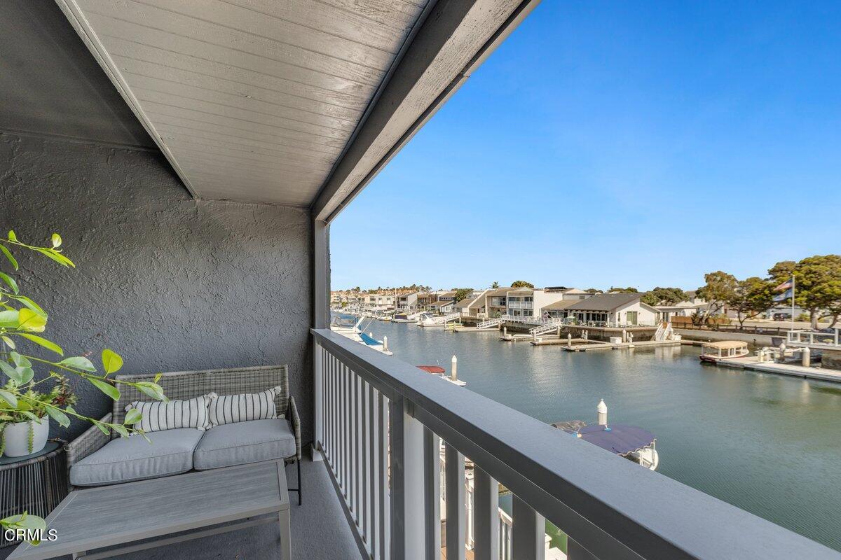 4612 Falkirk Bay Oxnard, CA 93035 - Photo 31 of 39 a balcony with wooden floor and lake view