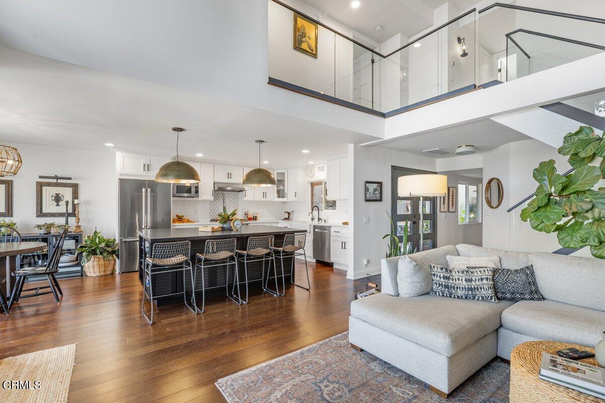 4612 Falkirk Bay Oxnard, CA 93035 - Photo 7 of 39 a living room with furniture a wooden floor and kitchen view
