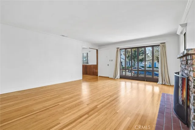 a view of a kitchen with wooden floor and a sink