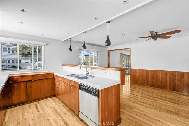 a kitchen with stainless steel appliances a stove a refrigerator and wooden cabinets