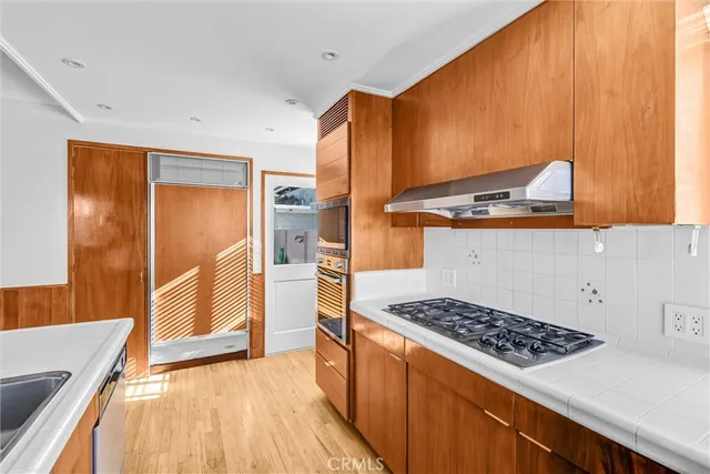 a kitchen with a sink a counter top space and a window