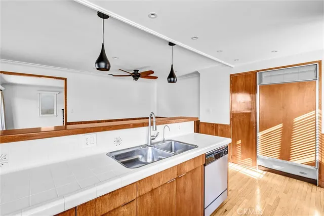 a view of a room with wooden floor and ceiling fan
