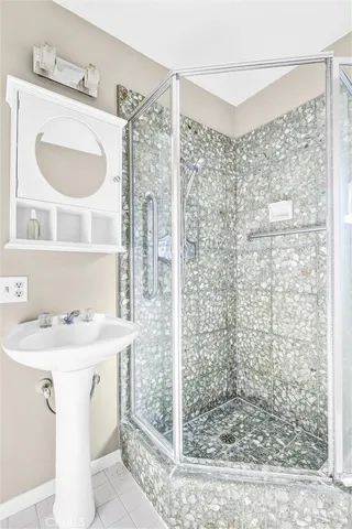 a bathroom with a sink a mirror and shower