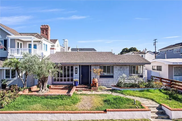 a front view of house with yard and outdoor seating