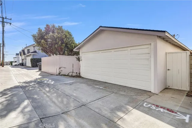 an aerial view of a city with lots of residential buildings and ocean view in back