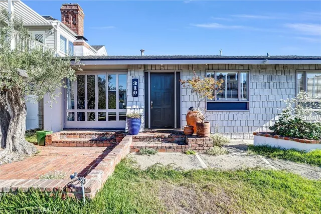 a view of empty room with wooden floor and fireplace