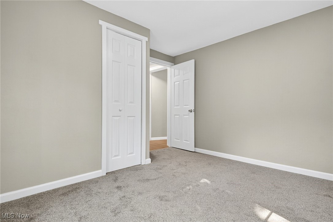 8230 Drake State Line Road Masury, OH 44438 - Photo 40 of 47 Unfurnished bedroom featuring baseboards and light carpet