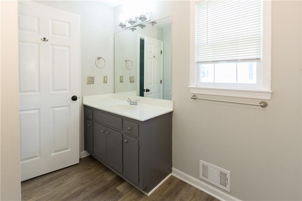 374 McGiboney Road Covington, GA 30016 - Photo 16 of 29 a bathroom with a sink mirror and a vanity