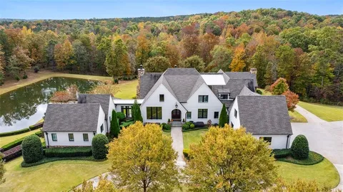 a aerial view of a house with swimming pool and a yard