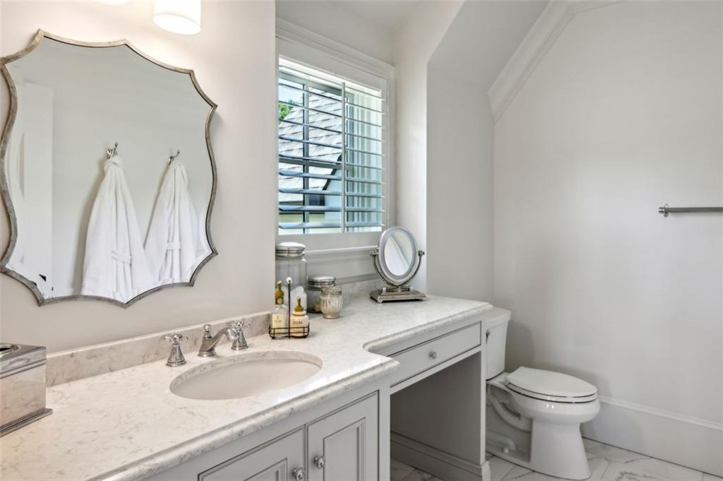 1990 Elder Mill Road Watkinsville, GA 30677 - Photo 23 of 61 a bathroom with a granite countertop toilet sink and mirror