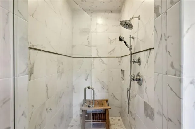 a bathroom with a double vanity sink mirror and shower