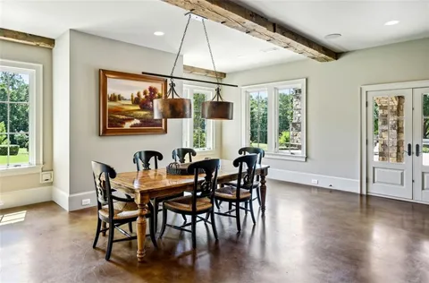a view of living room and deck with furniture and floor to ceiling window