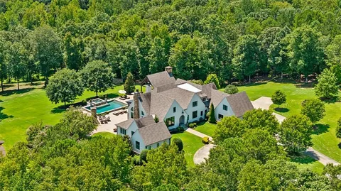 an aerial view of a house with yard swimming pool and outdoor seating